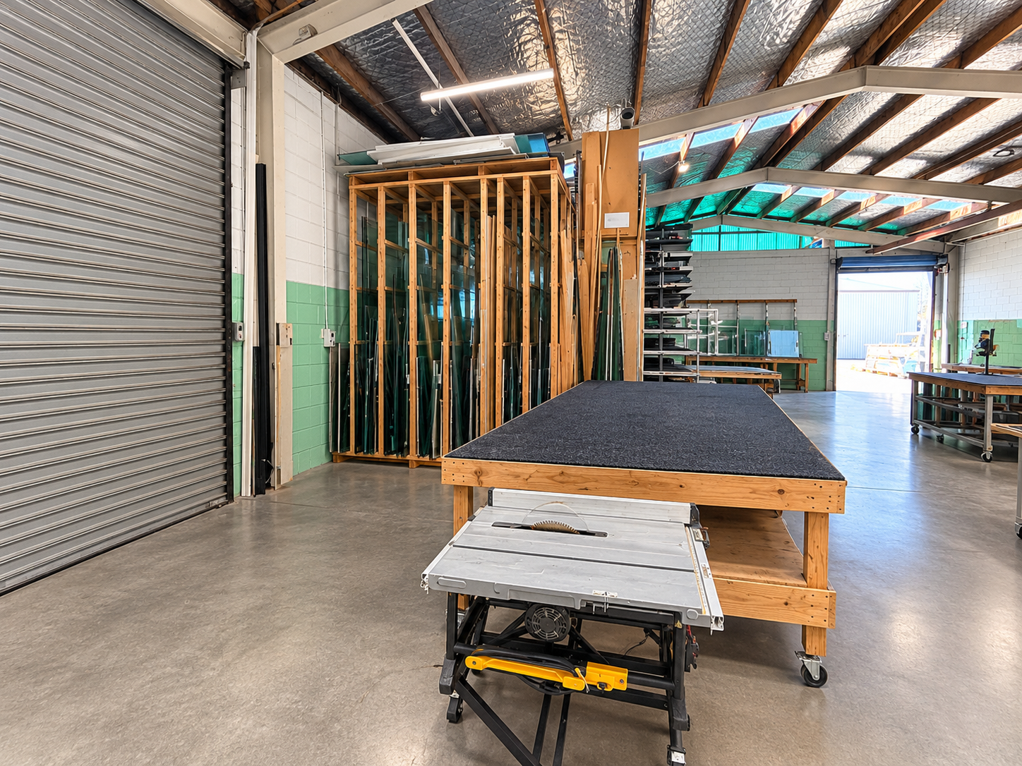 Inside the Cutting Edge workshop: cutting table, saw and glass racks